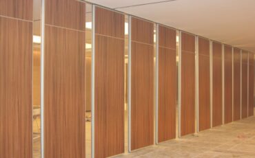 What are the advantages of wood-grain film-coated metal panels as a new favorite building material?
